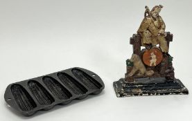 A Victorian doorstop decorated with polychrome enamels and raised on a stepped plinth base, probably