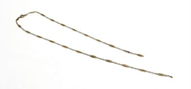 An Eastern inspired yellow metal oval beaded figure of eight and chain link necklace with ring