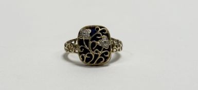 A 9ct gold ring in the middle eastern taste with lapis lazuli with gold wire work scrolls and