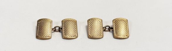 A pair of 9ct cast sleeve links with engine turned decoration on both sides: l. x 1cm w. x 1cm 9.1g