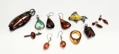 A collection of amber mounted jewellery to include a white metal mounted pendant: l. x 7cm, a ring