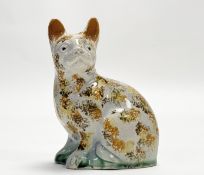 An early 19th creamware moulded seated ginger tabby cat with spongeware style decoration - note
