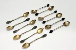 A George V Birmingham set of six silver gilt and enamel backed coffee bean handed spoons decorated