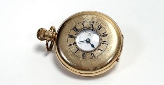 A Dennison gold plated half hunter pocket watch with white enamel dial and roman numerals and a