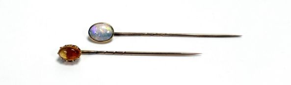 A yellow metal oval mounted water opal stick pin in rub over setting: l. x 6cm approximately 1ct
