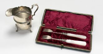 A George V Birmingham silver individual milk jug in the Georgian taste with a scalloped rim and