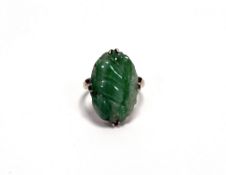 A Chinese yellow metal mounted oval green varigated celadon jade ring of three gourds mounted in