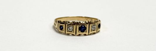 An Edwardian gold ring set central circular facet cut sapphire approximately 0.15ct flanked by a