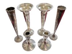 Pair of late Victorian silver spill vases with embossed foliate scroll decoration, another pair of s
