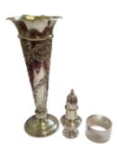 Edwardian silver spill vase with embossed floral scroll decoration, silver napkin ring and a silver