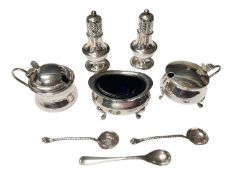Silver three piece condiment set with blue glass liners, five various silver salt spoons and a pair