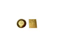 Two yellow metal nuggets, the round disc stamped 18 and rectangular plaque stamped 22