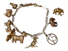 9ct gold fancy link charm bracelet with eight 9ct gold novelty charms and a loose gilt metal elephan