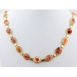 Collier mit Feueropal, 18 kt Gelbgold, mit Feueropal Cabochons in Matrix, B. 1,1 cm - 1,7 cm,