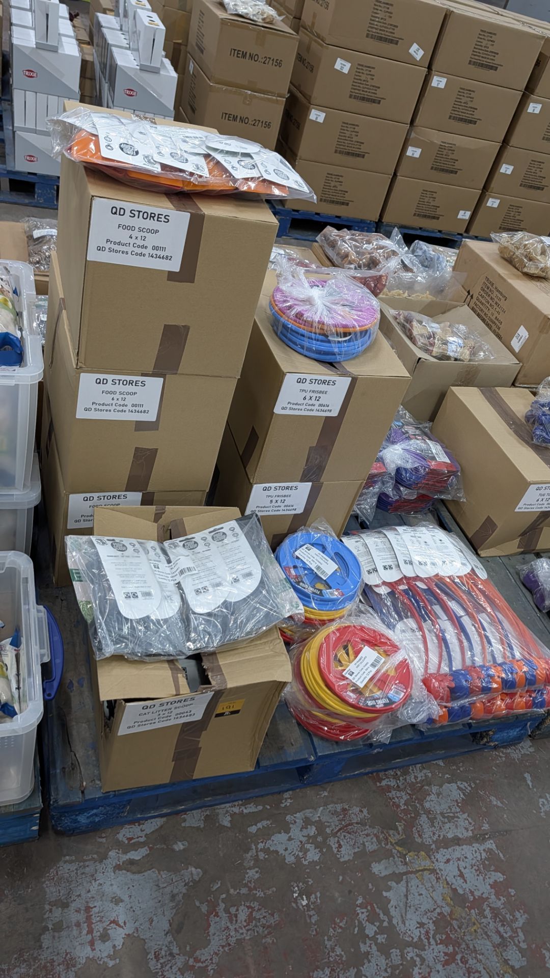 Contents of a Pallet of assorted Plastic Food Scoops and Poop Scoops, Flying Discs, Interactive Trea