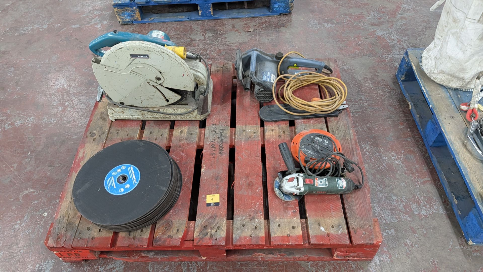 Contents of a Pallet comprising Makita 110V Chop Saw, Stack of Blades for same, Bosch 13A Angle Grin