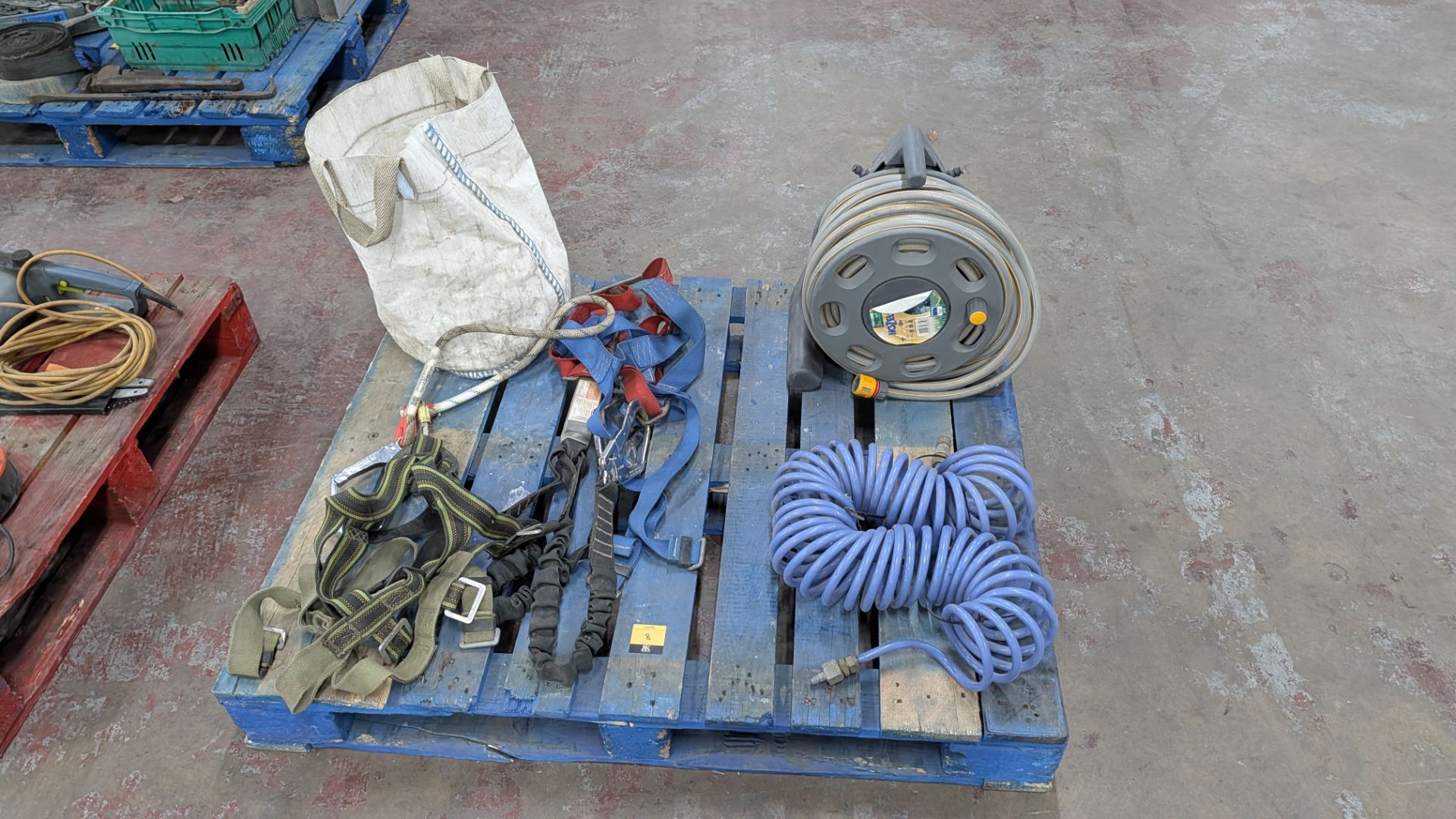 Contents of a Pallet comprising Safety Harnesses, Air Hose, Water Hose and Sack
