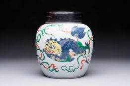 A fine Chinese famille verte 'Buddhist Lions' jar and a reticulated wooden cover, 19th C.