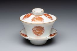 A fine Chinese iron-red gilt-decorated covered teabowl with a stand, Guangxu mark and of the period