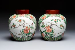 A pair of Chinese famille verte 'Floral' jars with wooden covers, 19th C.