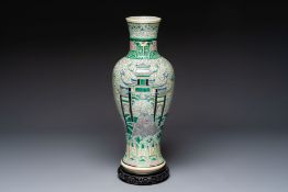 A Chinese verte biscuit 'Dragon Gate Carp' vase on a wooden stand, Xuande mark, 19th C.