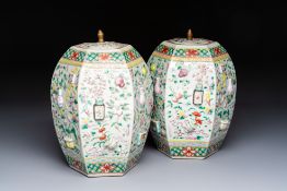 A pair of Chinese famille rose 'Antiquities' vases and covers, 19th C.