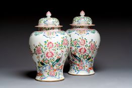 A pair of Chinese famille rose 'Phoenixes among Flowering Branches' vases and covers, 20th C.