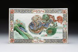 A Chinese famille verte 'Buddhist Lions' plaque, 19th C.