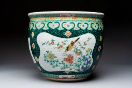 A Chinese famille verte black-ground jardiniere with birds, antiquities and flowers, 19th C.
