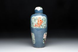 A Chinese famille verte powder-blue-ground 'Fish and Bird' vase and cover, 19th C.