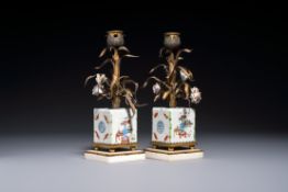 A pair of gilt silver and metal candlesticks with Chinese porcelain, European porcelain flowers, and