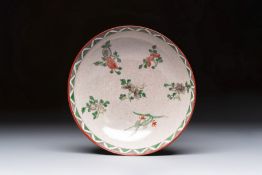 An unusual Chinese famille verte copper-red-ground shallow bowl with floral design, 19th C.