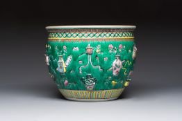 A Chinese famille rose green-ground 'Antiquities' fish bowl or jardiniere with applied relief design