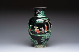 An unusual Chinese famille noire vase with relief design, Kangxi mark, 19th C.