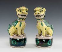 PAIR OF CHINESE FAMILLE VERTE PORCELAIN BUDDHISTIC LIONS, seated on large drums, decorated in the