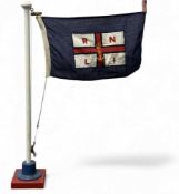 RNLI CLOTH FLAG, 46 x 28cms, hung on a painted wooden pole with circular cast-iron stand, 81cms (