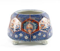 LARGE JAPANESE HEXAGONAL BOWL / PLANTER, 19th century, decorated in Imari palette and on four paw