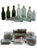 NINE VARIOUS MODEL SHIPS IN BOTTLES, two in Hague dimple bottles and two mounted on oak stands, with