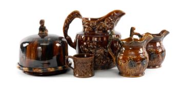 SELECTION OF VICTORIAN TREACLE GLAZED POTTERY, including cheese dish and cover, 22.5cms (diam.);