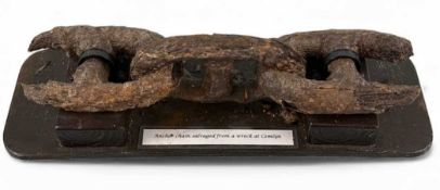 SECTION OF ANTIQUE ANCHOR CHAIN, salvaged from a wreck at Cemlyn, Ynys Môn, 54cms (l), mounted on