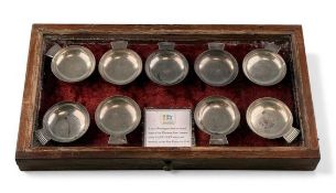 COLLECTION OF NINE METAL PORRINGERS, used on board ships of the Ellerman line, contained in a glazed