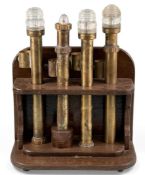 FOUR SHIP'S NAVIGATIONAL POST LAMPS, with brass columns, 48cms (h), with a wooden display stand