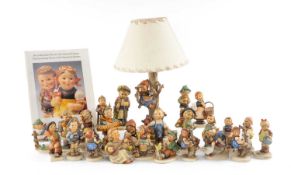 GOEBEL HUMMEL FIGURINES, children, collection of 25; and table lamp featuring girl in tree, dog