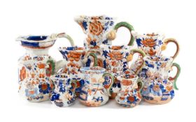 TEN IRONSTONE HYDRA PANELLED JUGS, Imari style decoration with serpent handles, 19th century, Masons