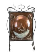 ARTS & CRAFTS PERIOD COPPER & WROUGHT IRON FIRE SCREEN, centred with a raised oval and stylised