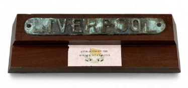 BRASS PLAQUE 'LIVERPOOL', with raised letters, verdigris finish, purported to be White Star Line,