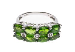 9K WHITE GOLD DRESS RING, set with two rows of oval-cut green stones and three white round gems,