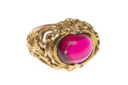 YELLOW METAL RED STONE CABOCHON RING, pierced setting, stamped '375', 8.2g Provenance: private