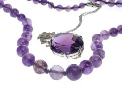 STRIKING AMETHYST & DIAMOND PENDANT NECKLACE, in 9ct white gold, the oval-cut amethyst of good