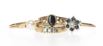FOUR 9CT GOLD RINGS comprising cultured pearl ring, white three-stone ring, diamond chip and